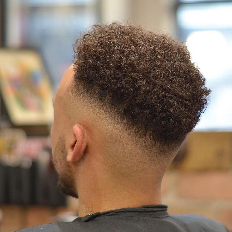 Mid fade haircut with curly hair Black men